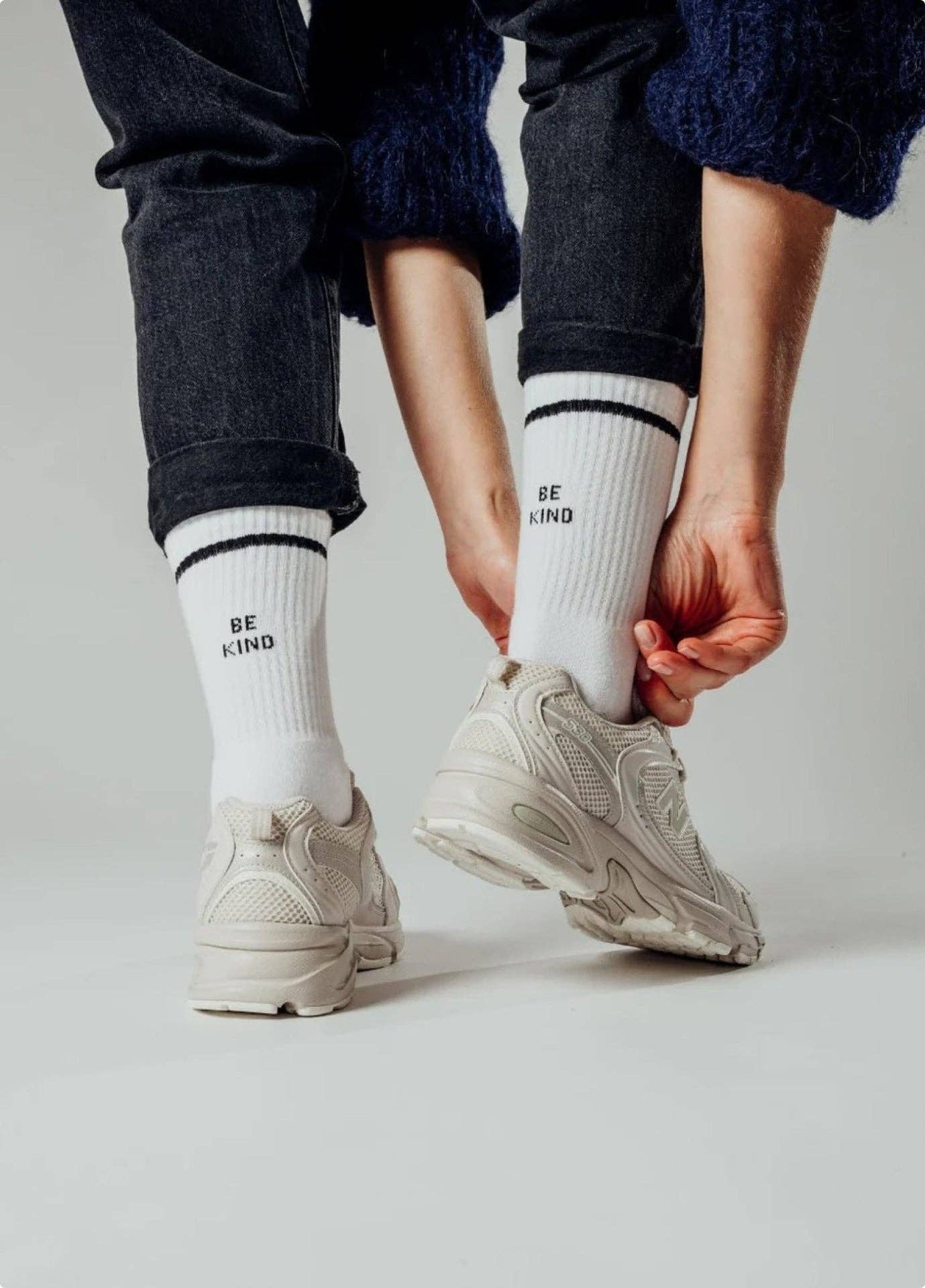BE KIND Statement Socken von NBDC in Weiß mit schwarzem Schriftzug mit Schuhe und Hose – Nohna