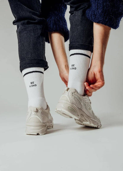 BE KIND Statement Socken von NBDC in Weiß mit schwarzem Schriftzug mit Schuhe und Hose – Nohna
