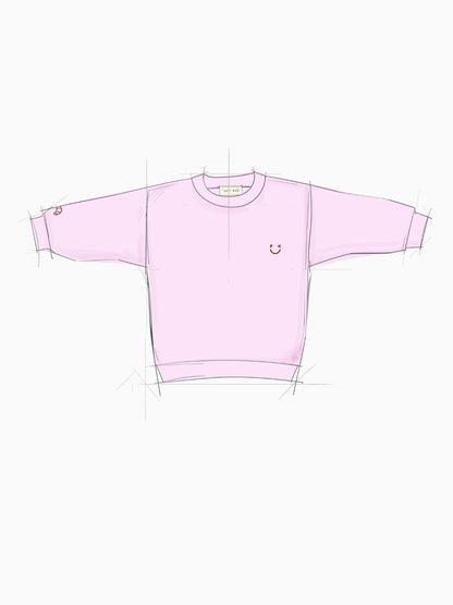 Croissant Sweatshirt Unisex in hellem Rosa mit Smiley-Print und Croissant-Stickerei am Ärmel - Grafik Frontansicht – Nohna