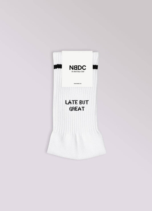 LATE BUT GREAT Statement Socken von NBDC in Weiß mit schwarzem Schriftzug Produktverpackung – Nohna